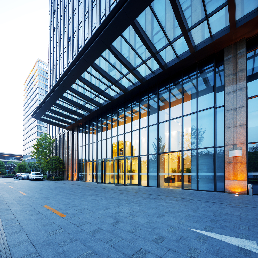 Modern Office Building Entrance | Commercial Property Modern office building entrance with glass façade, steel canopy, and commercial architecture.