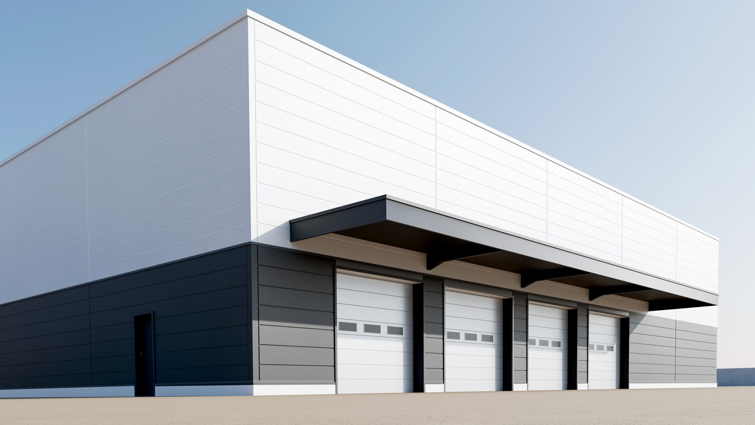 Commercial warehouse building with multiple loading dock doors and modern industrial exterior