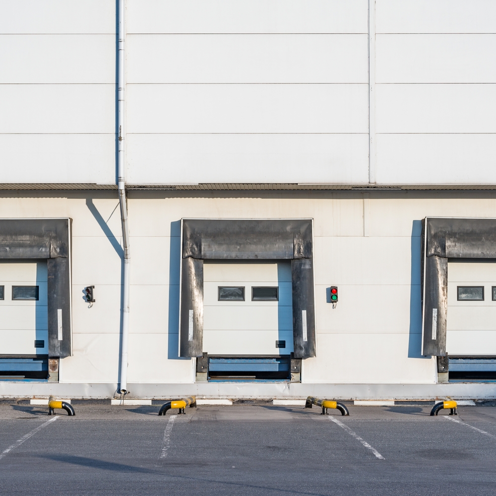 Warehouse Loading Docks | Industrial Facility Industrial warehouse loading docks with dock seals, overhead doors, and loading bays.