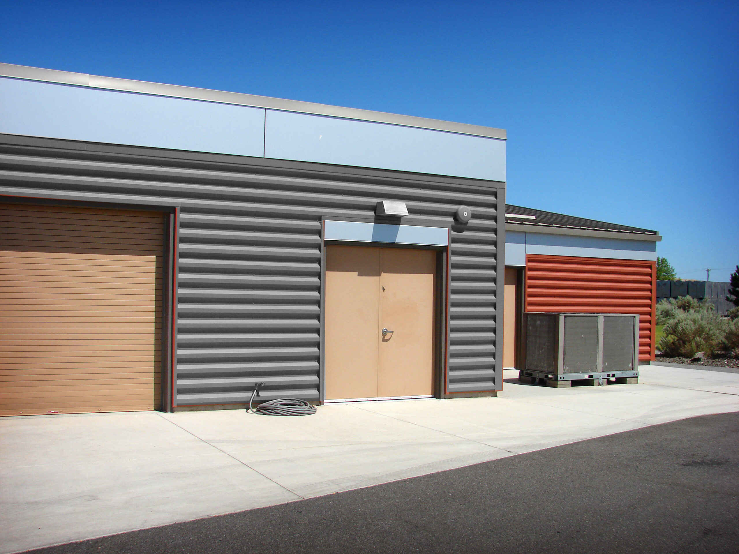 Modern industrial flex building with overhead doors inspected during a commercial property inspection in Utah.